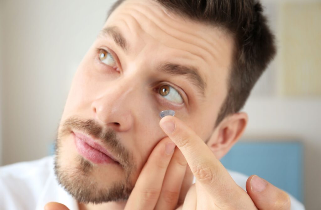 Man putting in a contact lens.