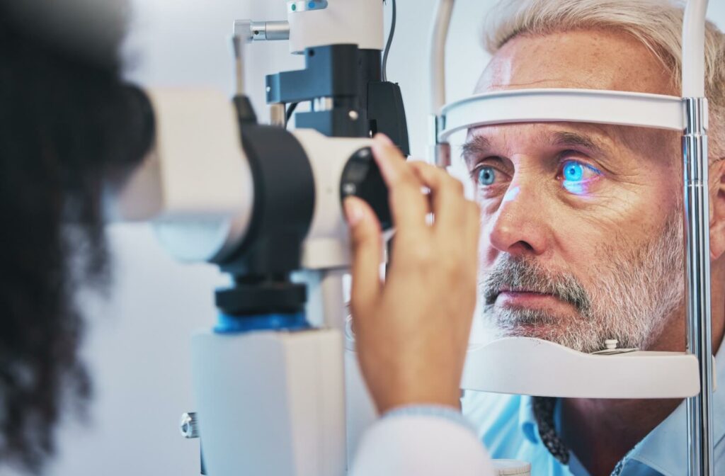 Older man being examined by slit lamp.