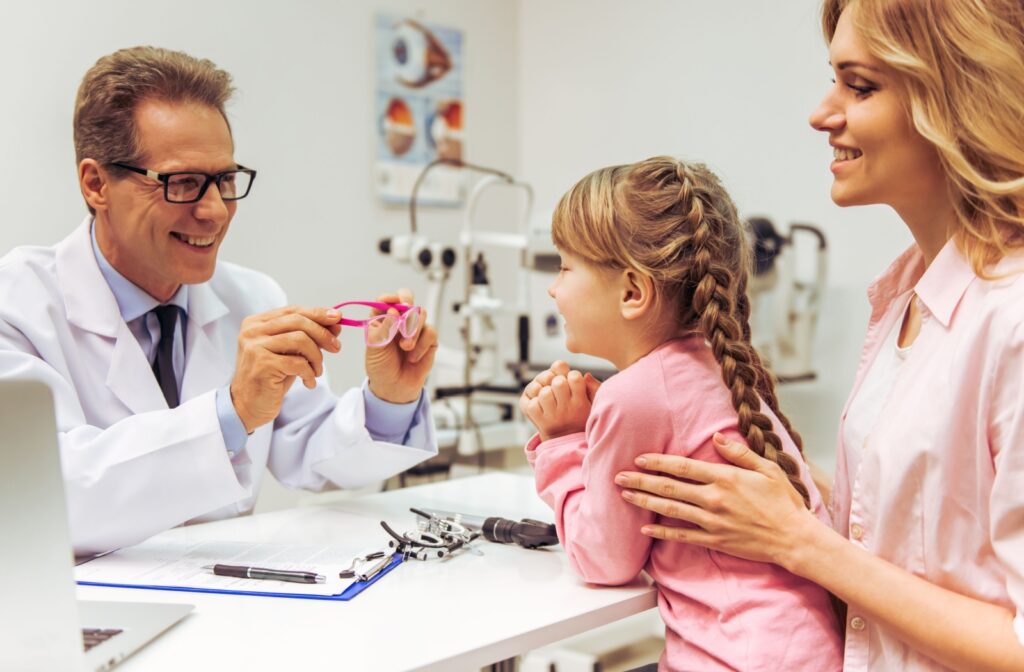 An optometrist discusses myopia control options with a young patient and their mother.