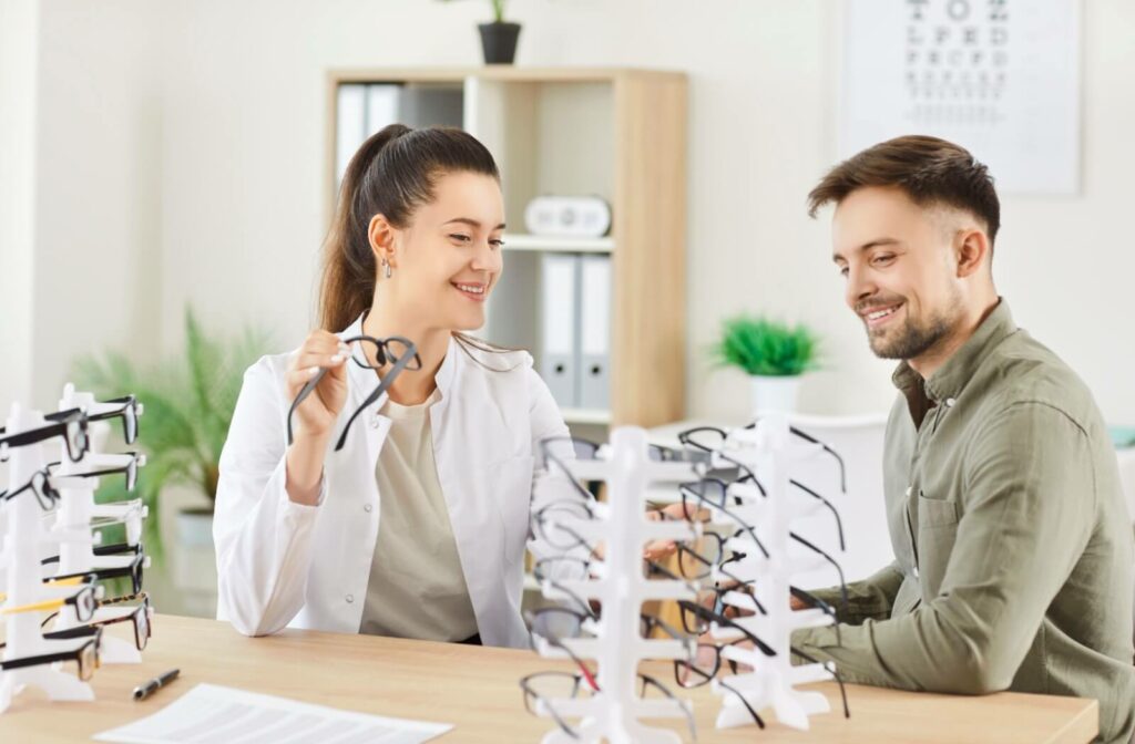 An optician helps a patient choose reading glasses that will help with their vision needs and relieve eye strain.